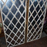 pair of iron framed mirrored windows