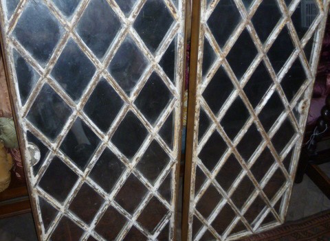 pair of iron framed mirrored windows